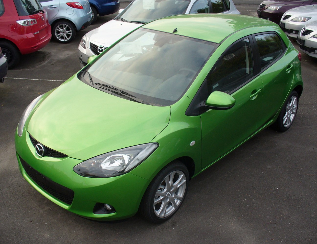 Green hatchback front-three-quarter view with alloy wheels