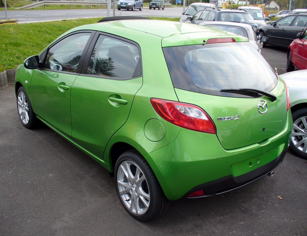Green hatchback rear view with distinct taillights and alloy wheels