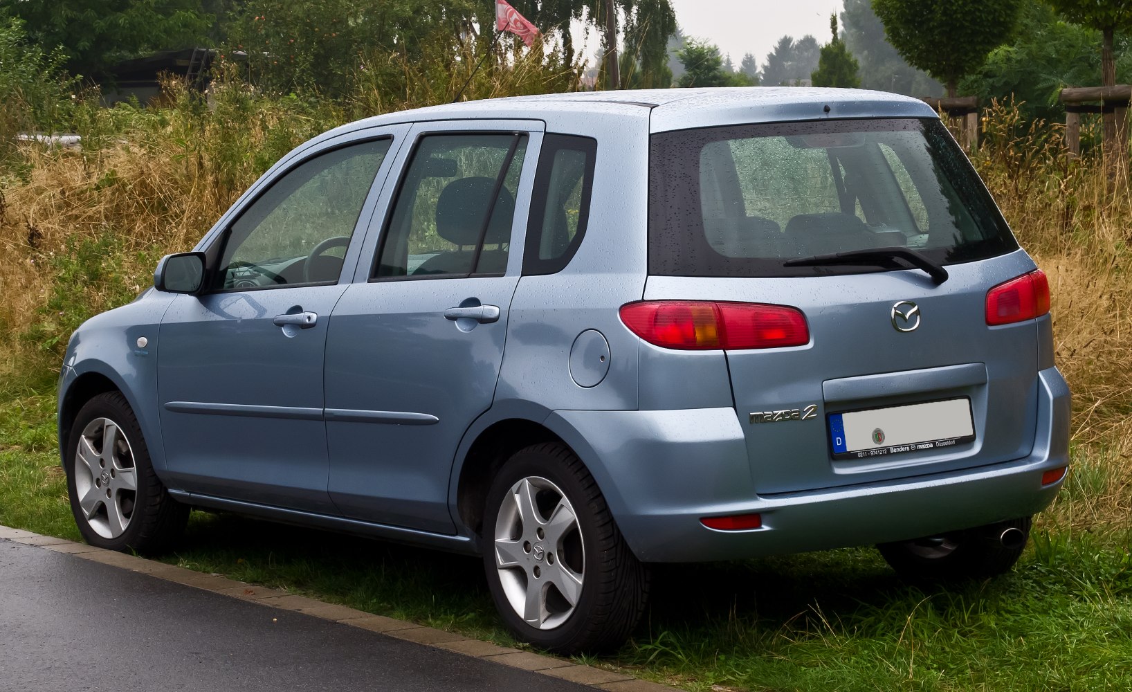 Rear and side view of a compact hatchback with distinct taillights and five-spoke wheels
