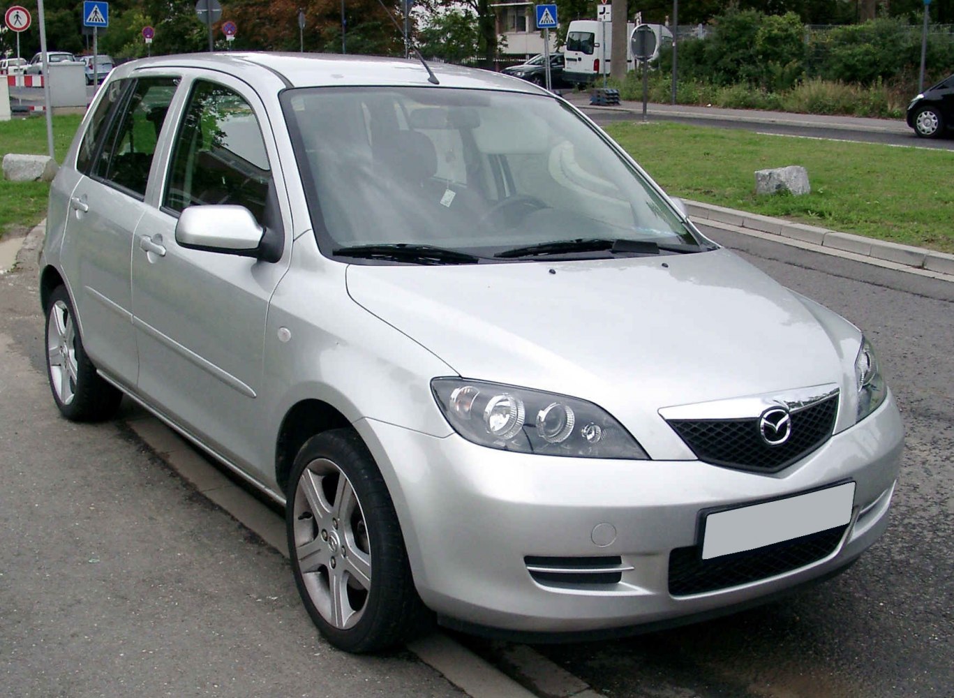 Silver 5-door hatchback front-left view with alloy wheels and sporty headlights
