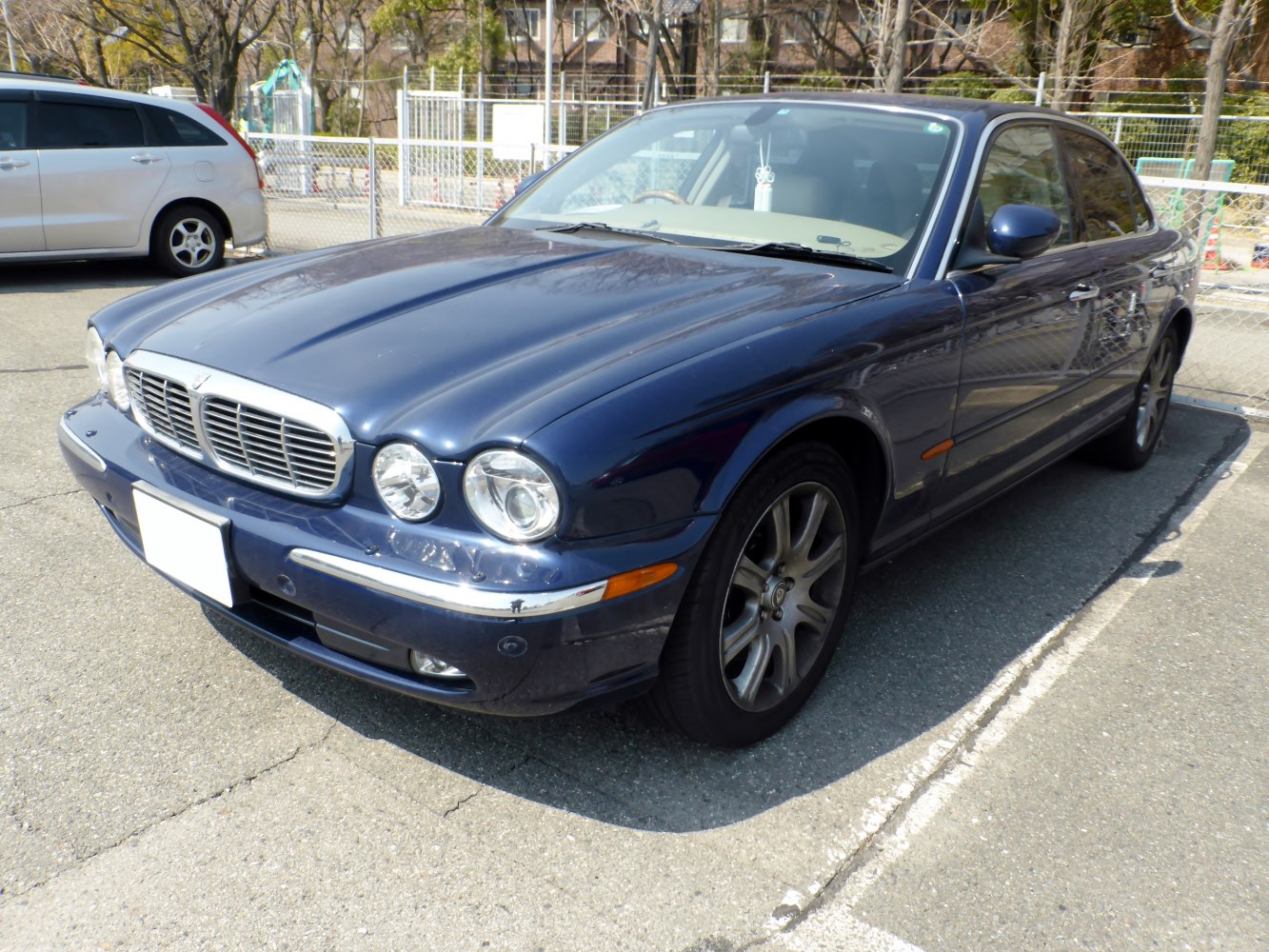 Front side view of a luxury sedan with distinctive rounded headlights