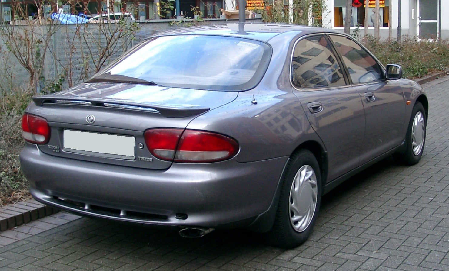 Rear view of sedan with rear spoiler and distinctive taillights