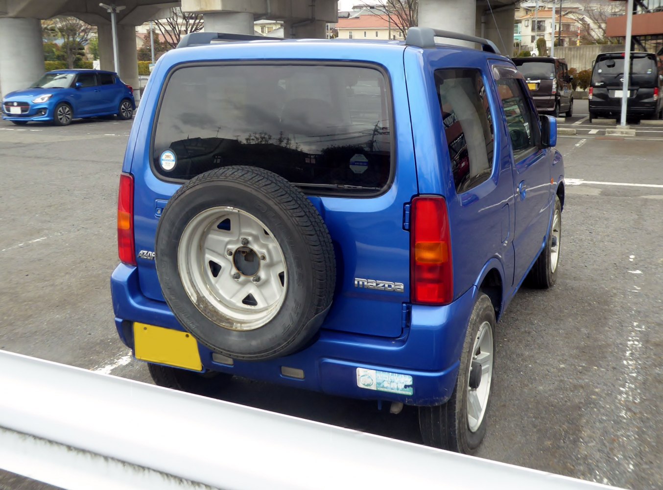 Compact SUV rear view with mounted spare wheel and tinted rear window
