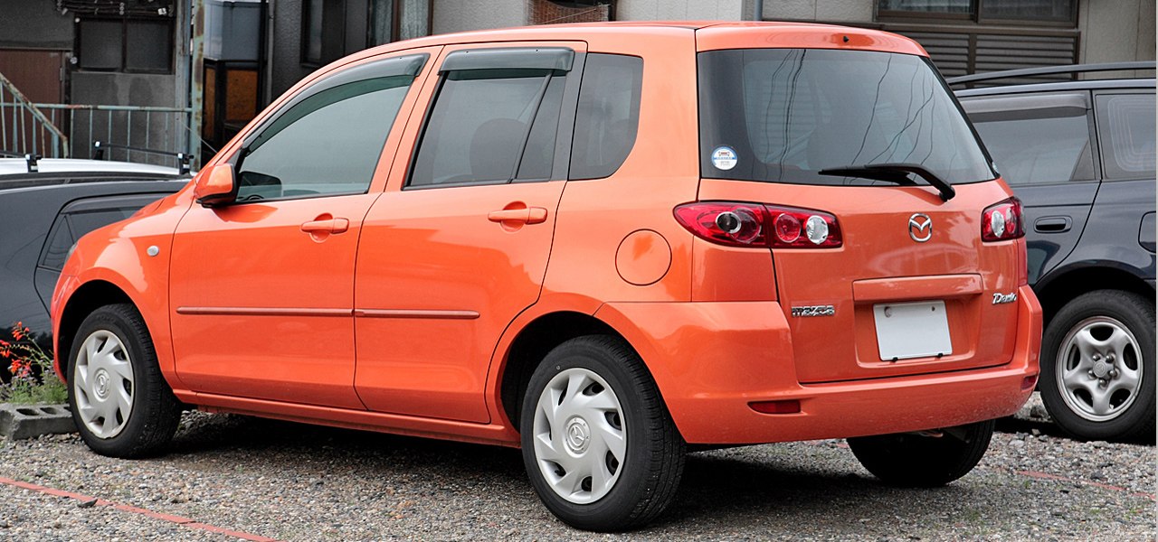 Orange compact hatchback with unique rear lights and side profile