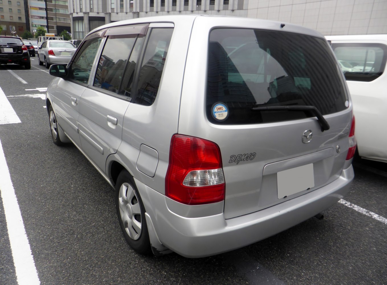 Silver compact hatchback rear view with distinct taillights and rear windshield wiper