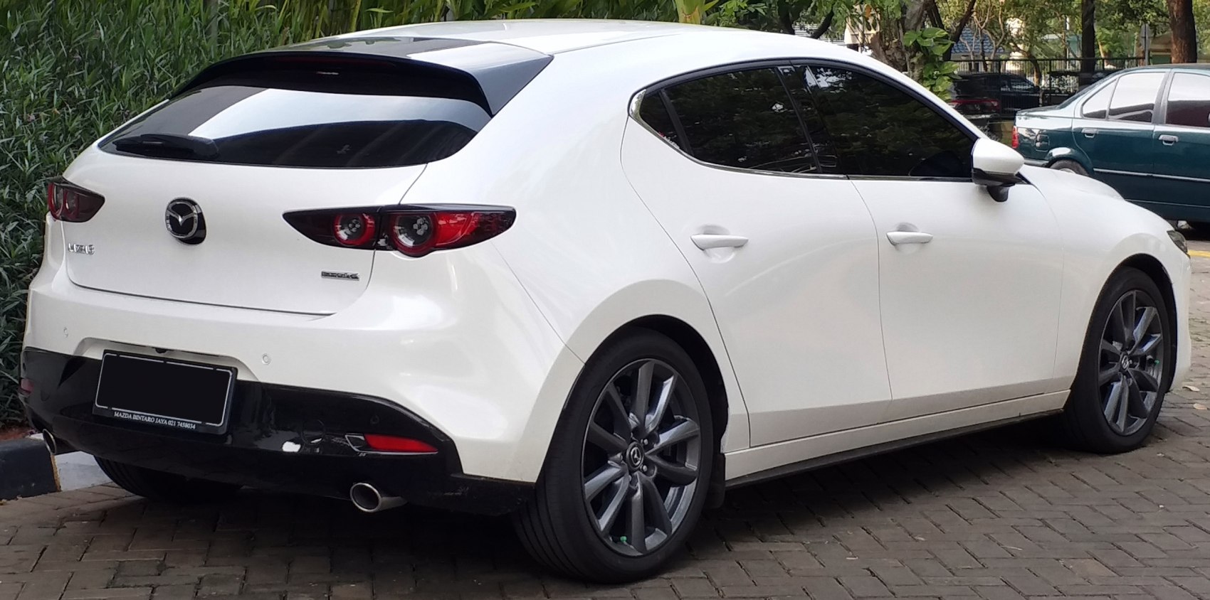 Rear and side profile with alloy wheels and sporty spoiler