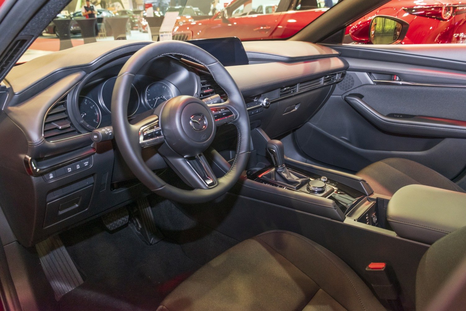 Car interior with dashboard, steering wheel, and center console