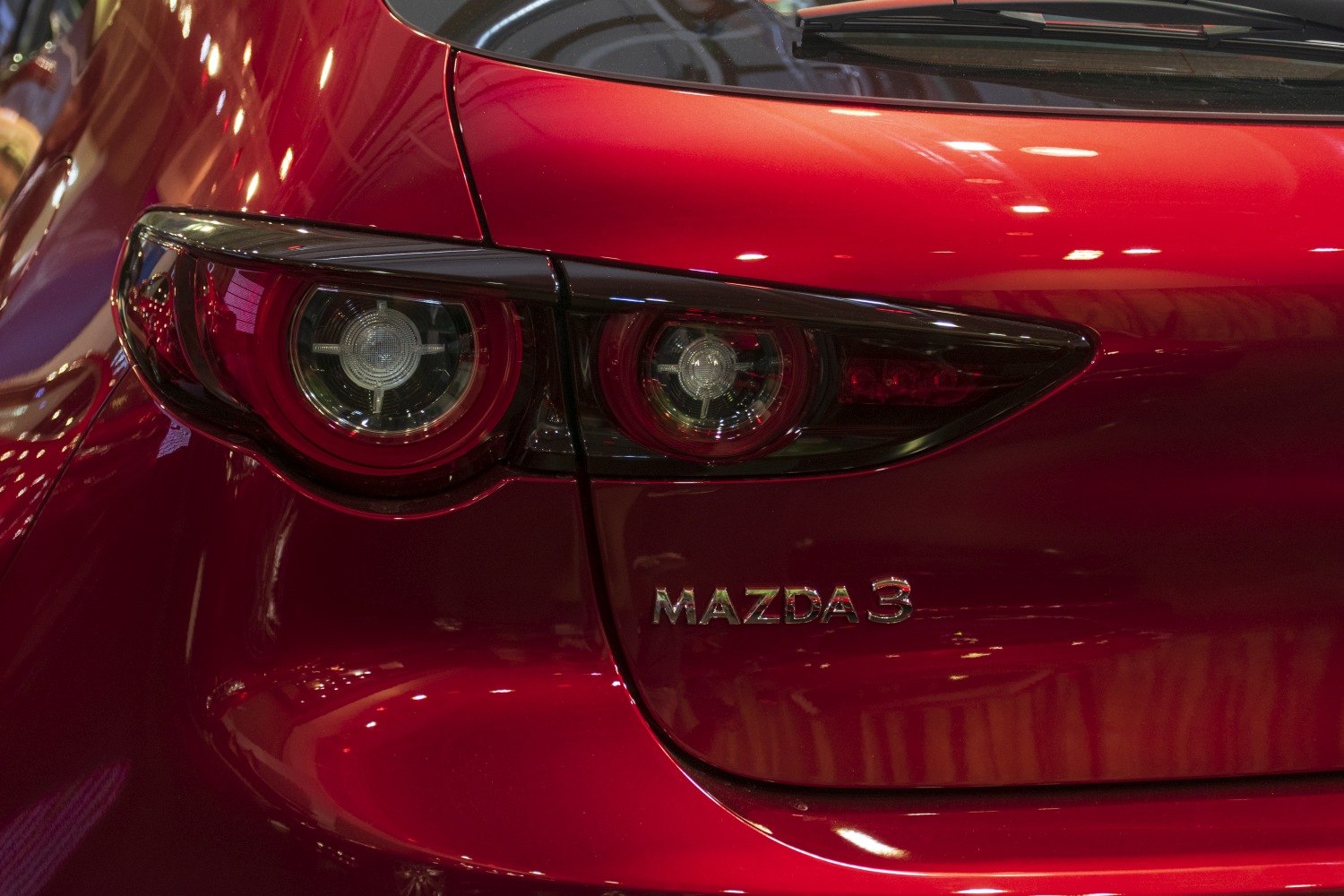 Close-up of dual round tail lights and red rear hatch