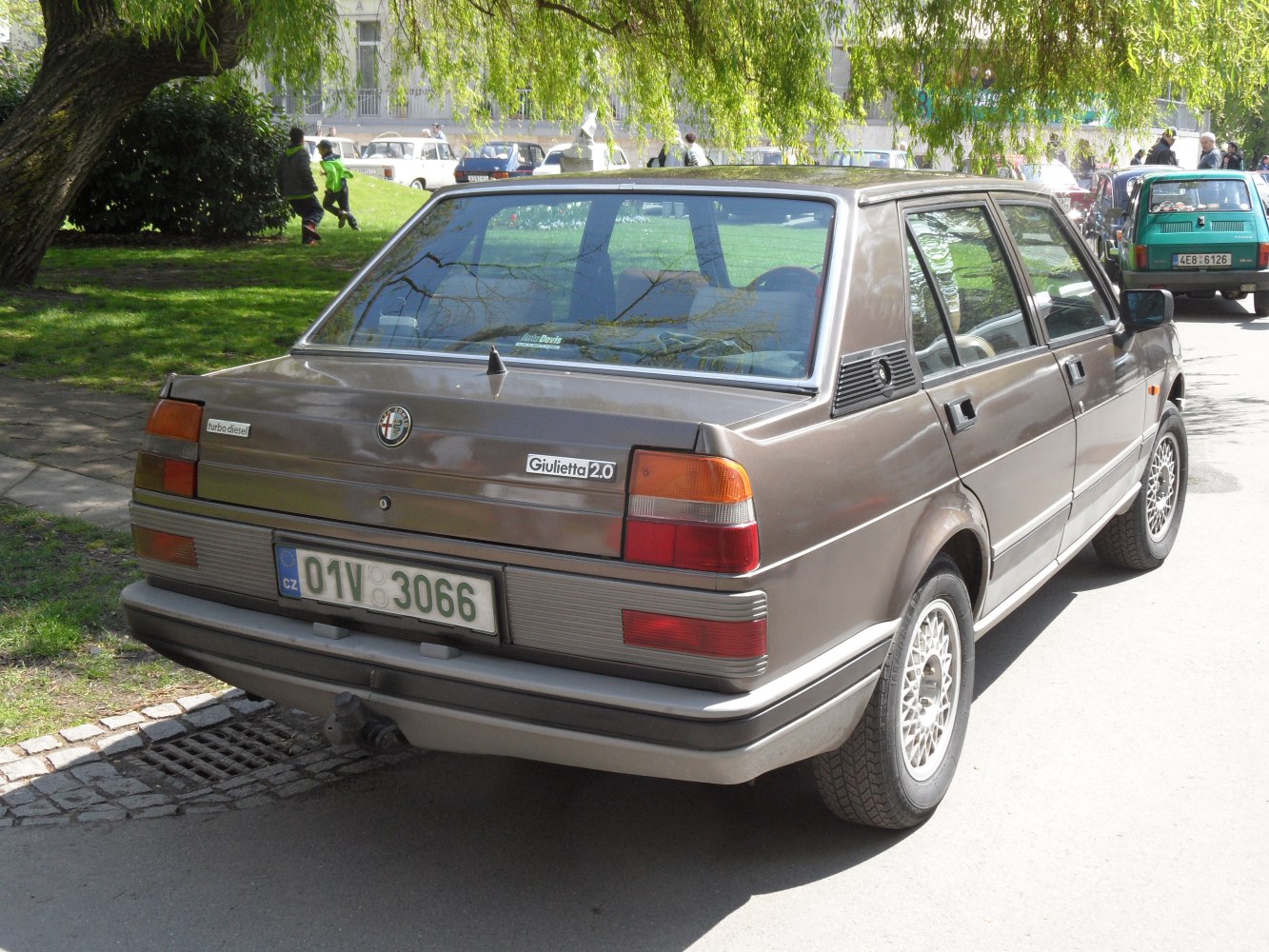 Rear view of vintage sedan with distinctive taillights and alloy wheels