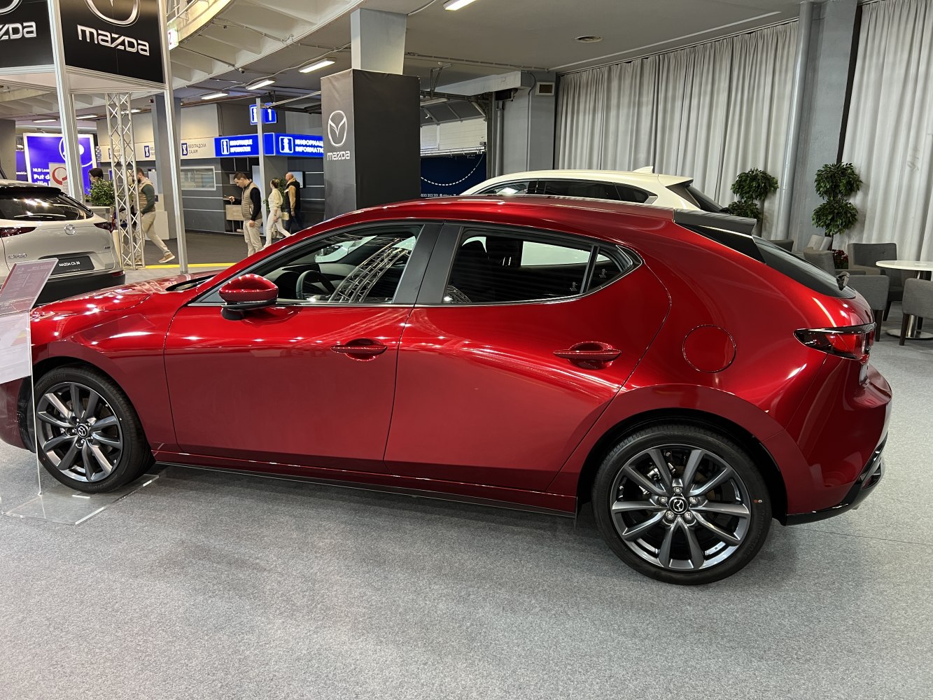 Side profile of red hatchback with alloy wheels