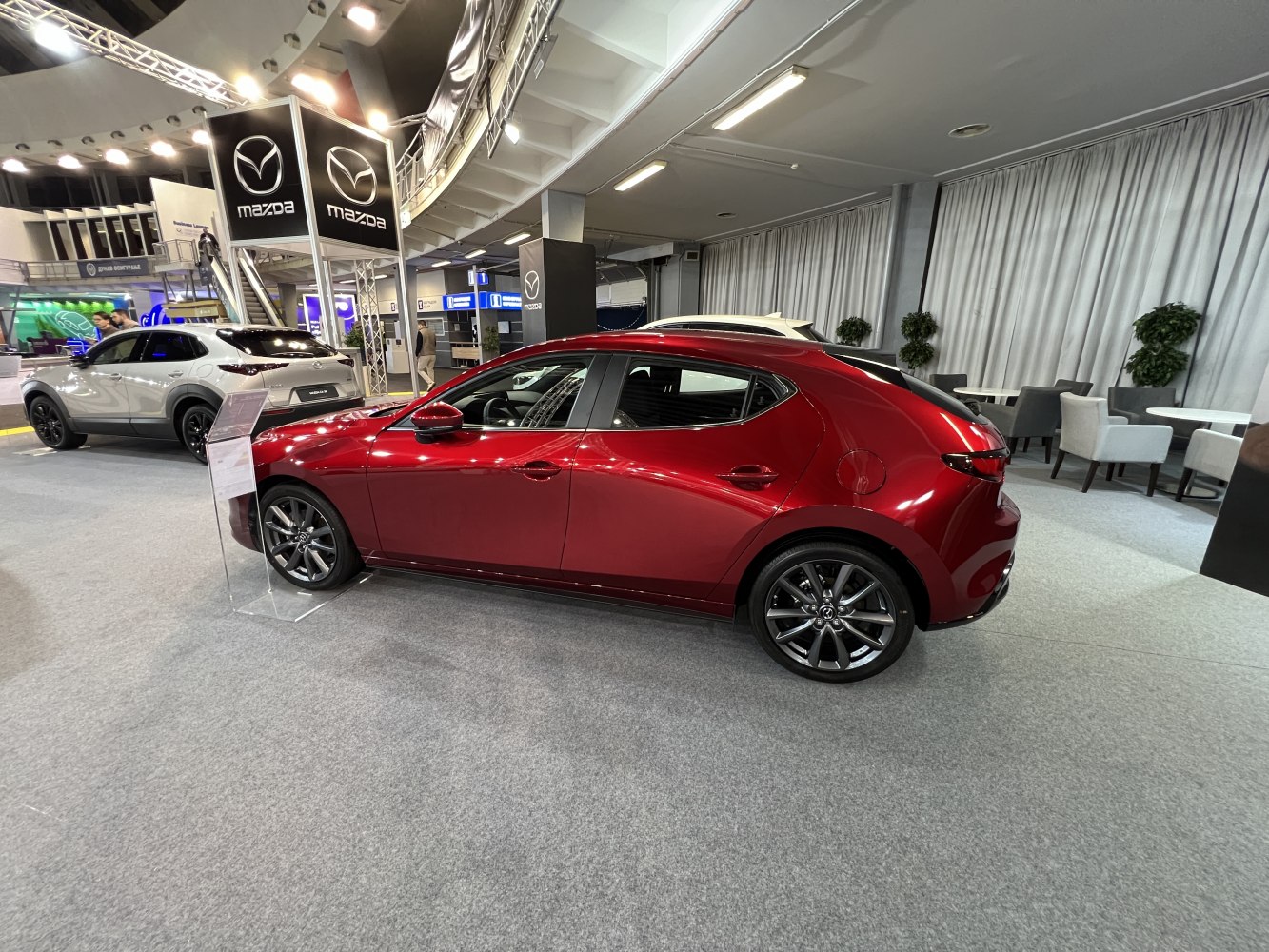 Side profile of a sleek hatchback with alloy wheels and smooth design lines.