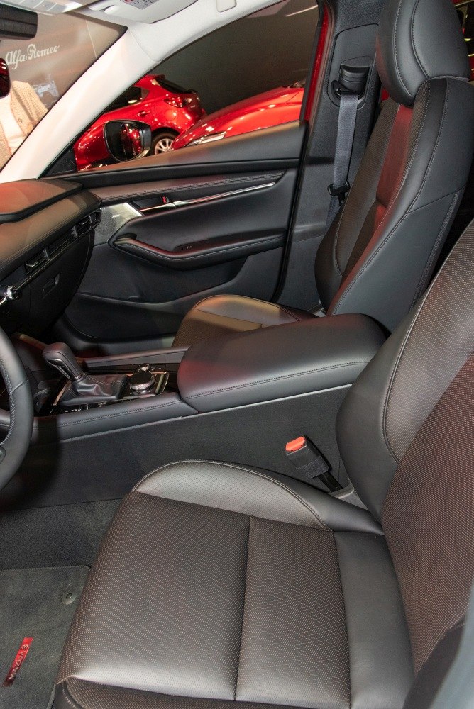 Modern car interior with leather seats and center console controls