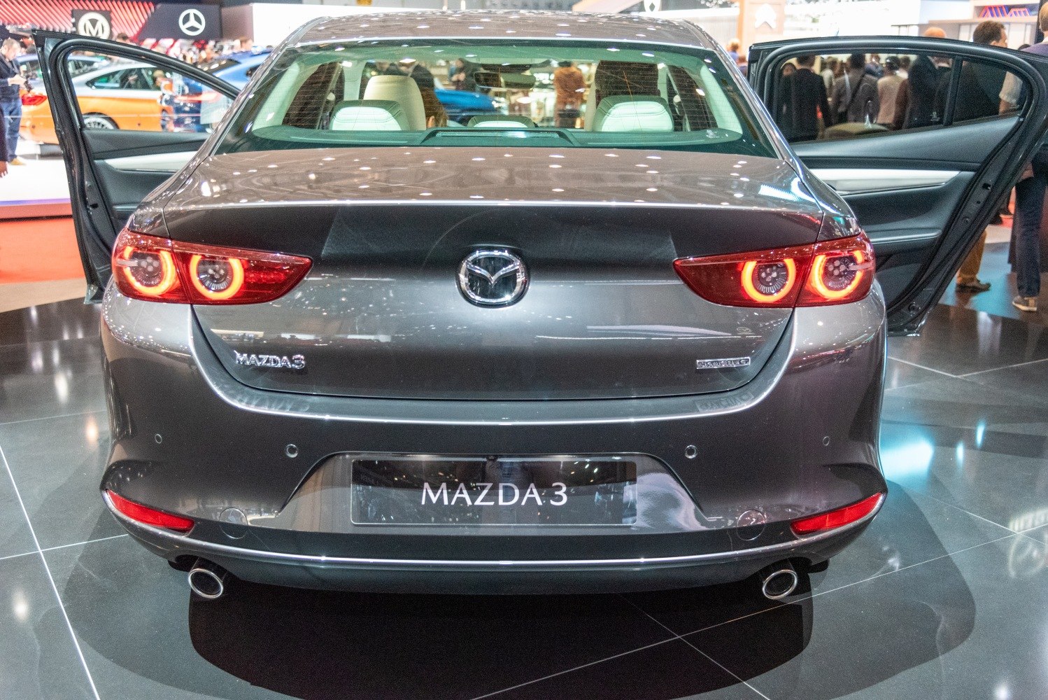 Rear view with circular LED tail lights and dual exhaust pipes