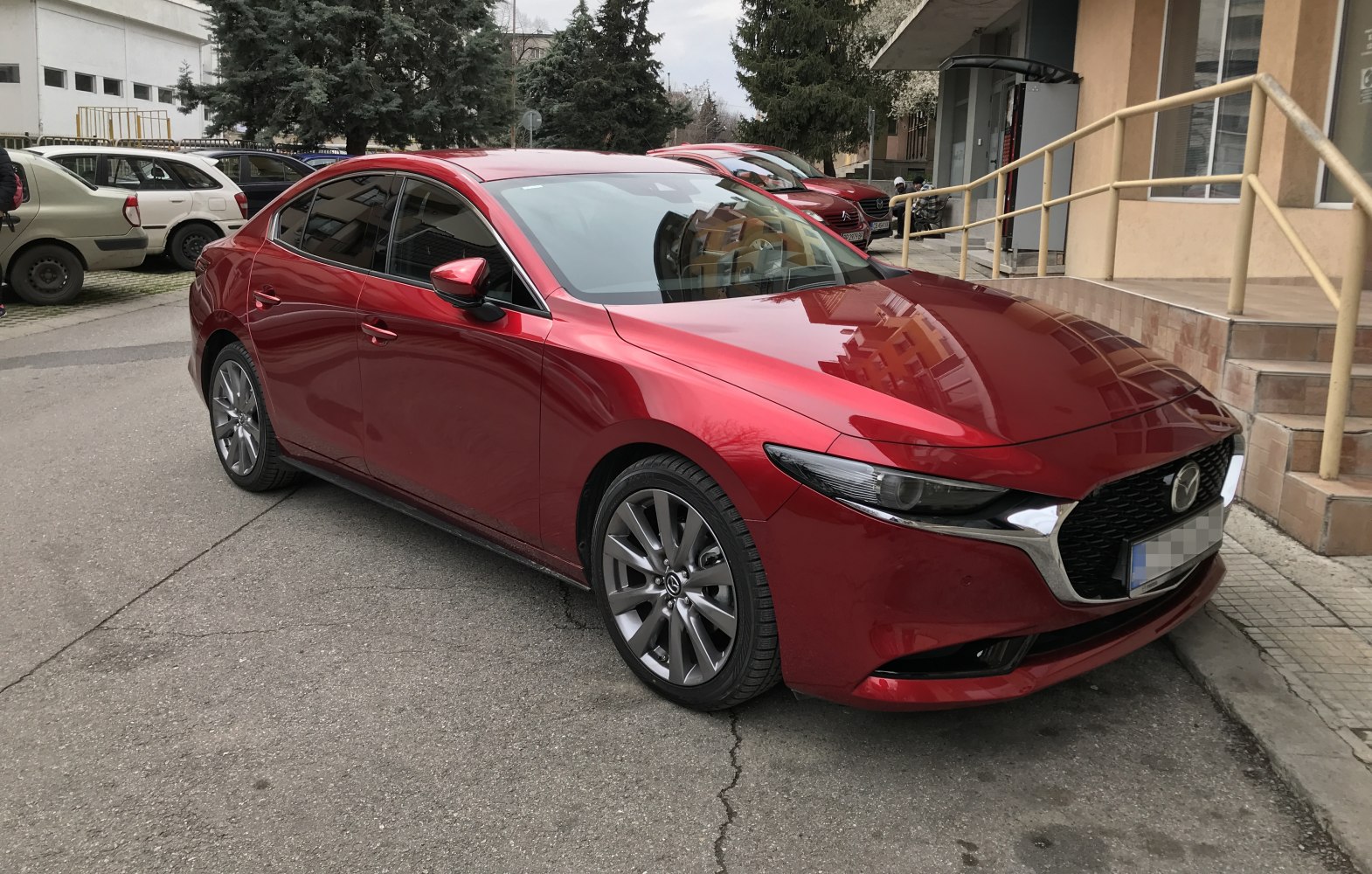 Red sedan with alloy wheels and LED headlights