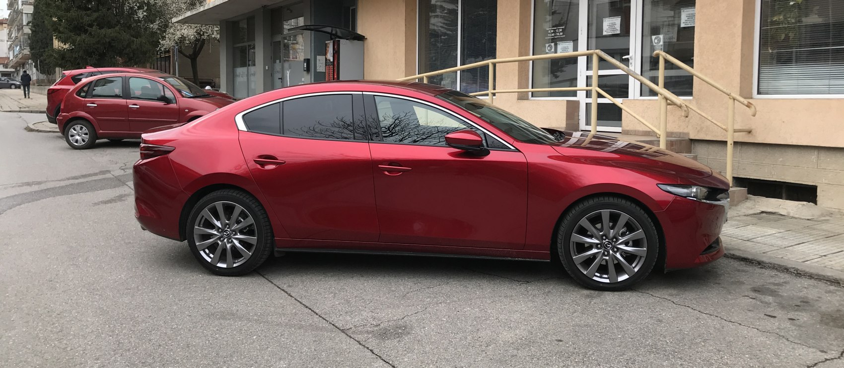 Sleek sedan side profile with tinted windows and stylish alloy wheels