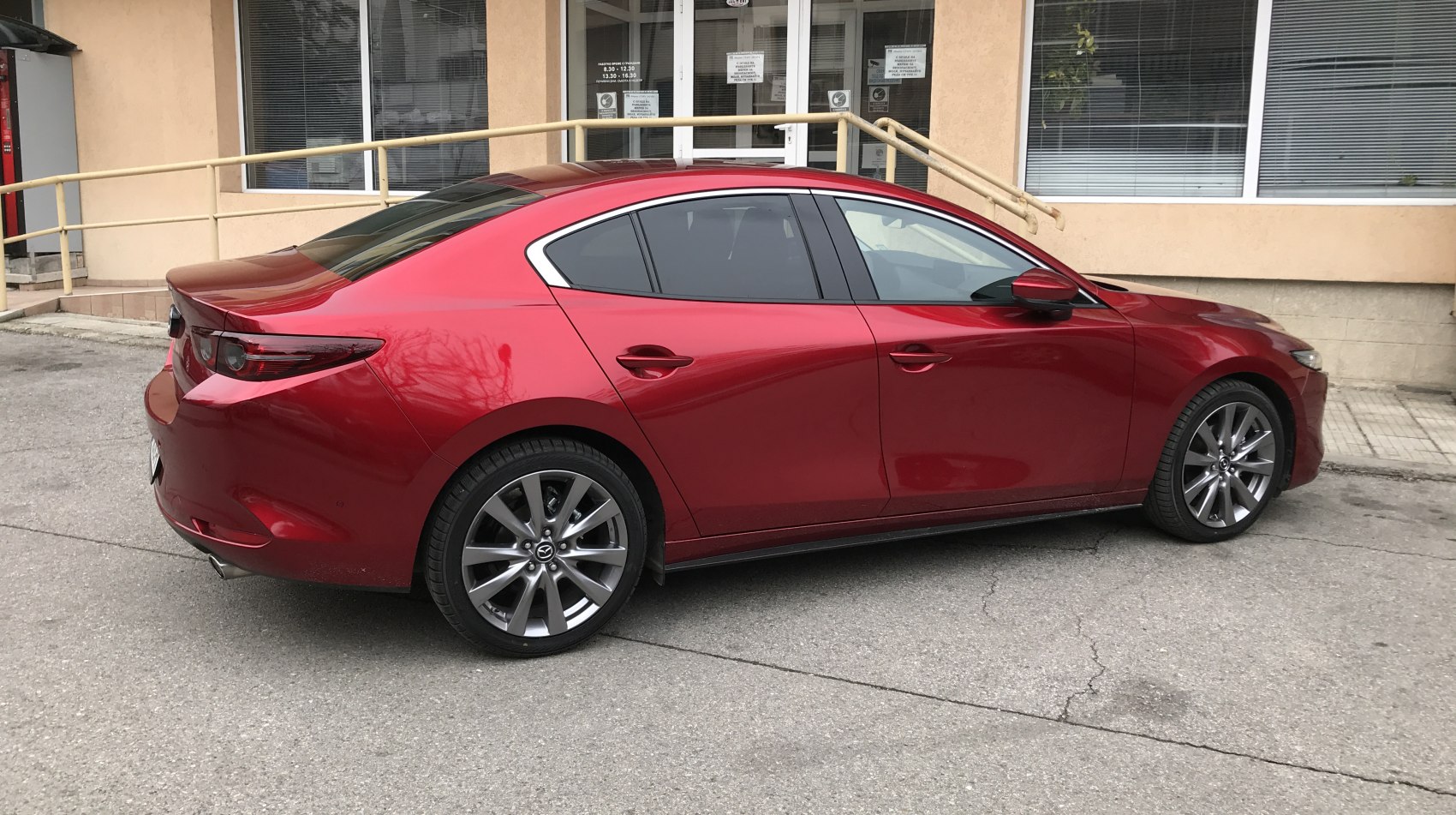 Rear side view of sedan with alloy wheels