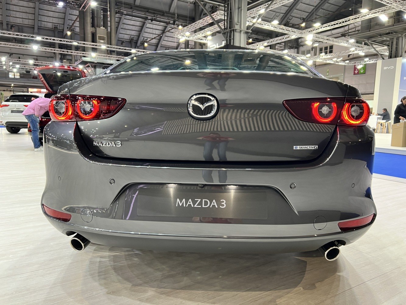 Rear view with circular tail lights and dual exhausts.