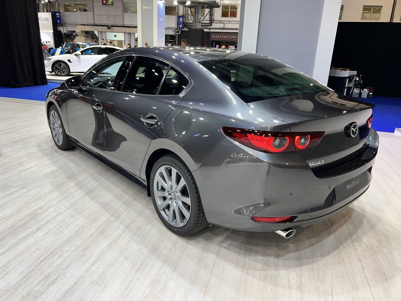 Rear of a modern sedan with LED taillights and alloy wheels