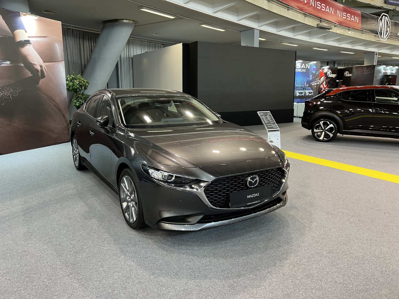 Front view of sleek grey sedan with distinctive grille and sharp headlights.