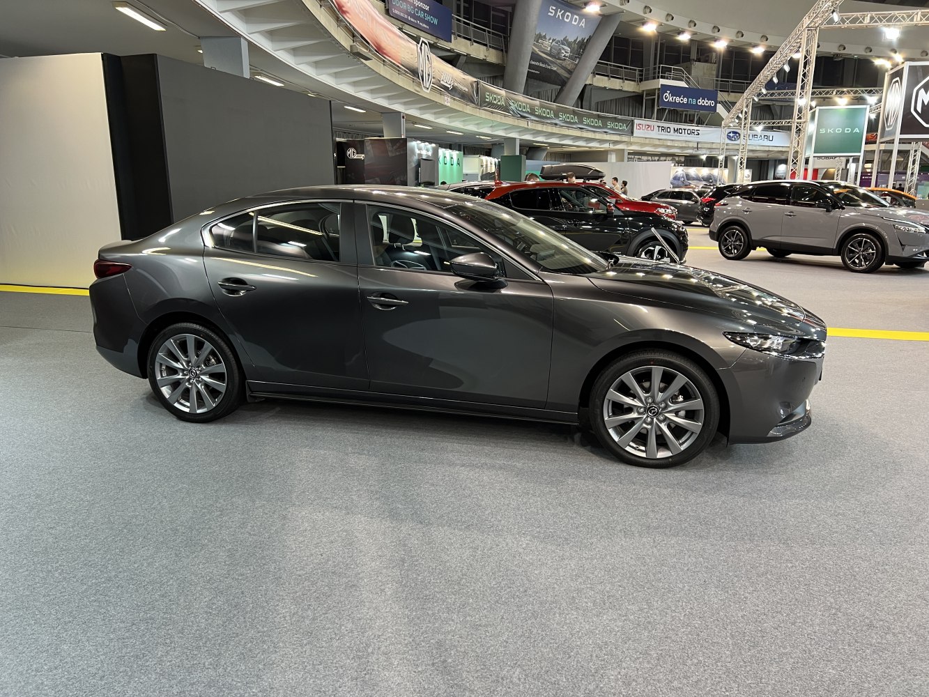 Sleek modern sedan side profile with alloy wheels and aerodynamic design