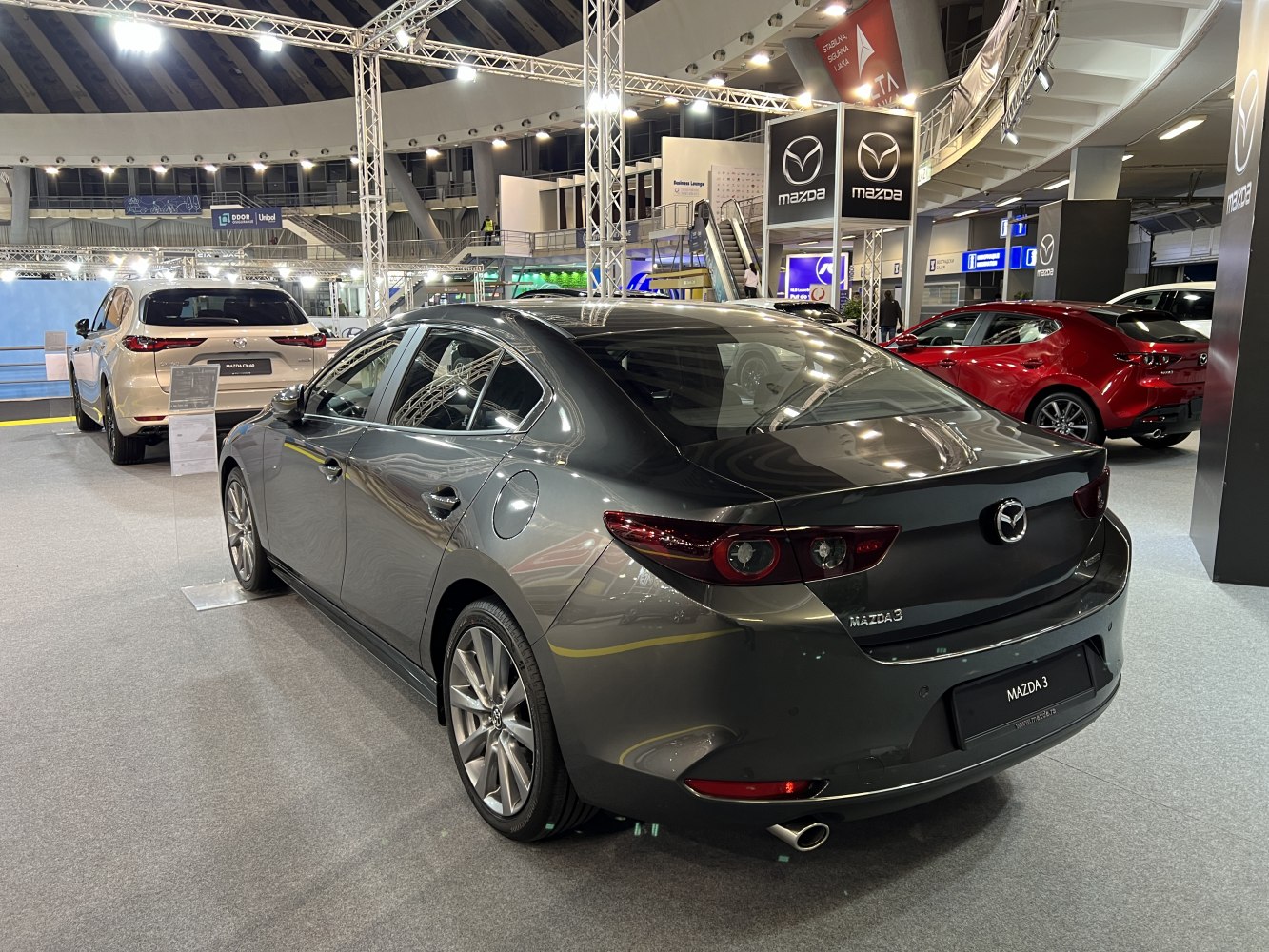 Rear and side profile of modern sedan with alloy wheels and sleek tail lights