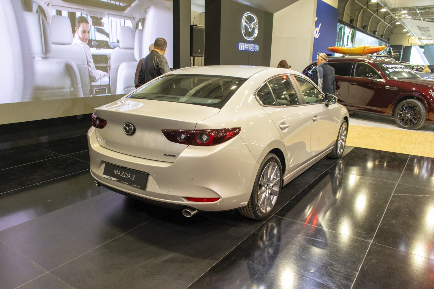 Rear and side profile of modern sedan with distinctive taillights and dual exhaust