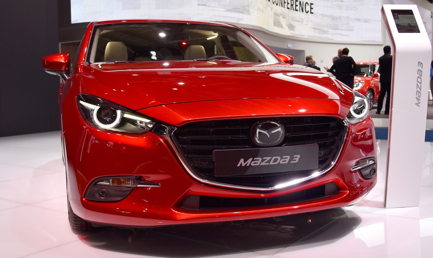 Front grille and LED headlights of a red hatchback