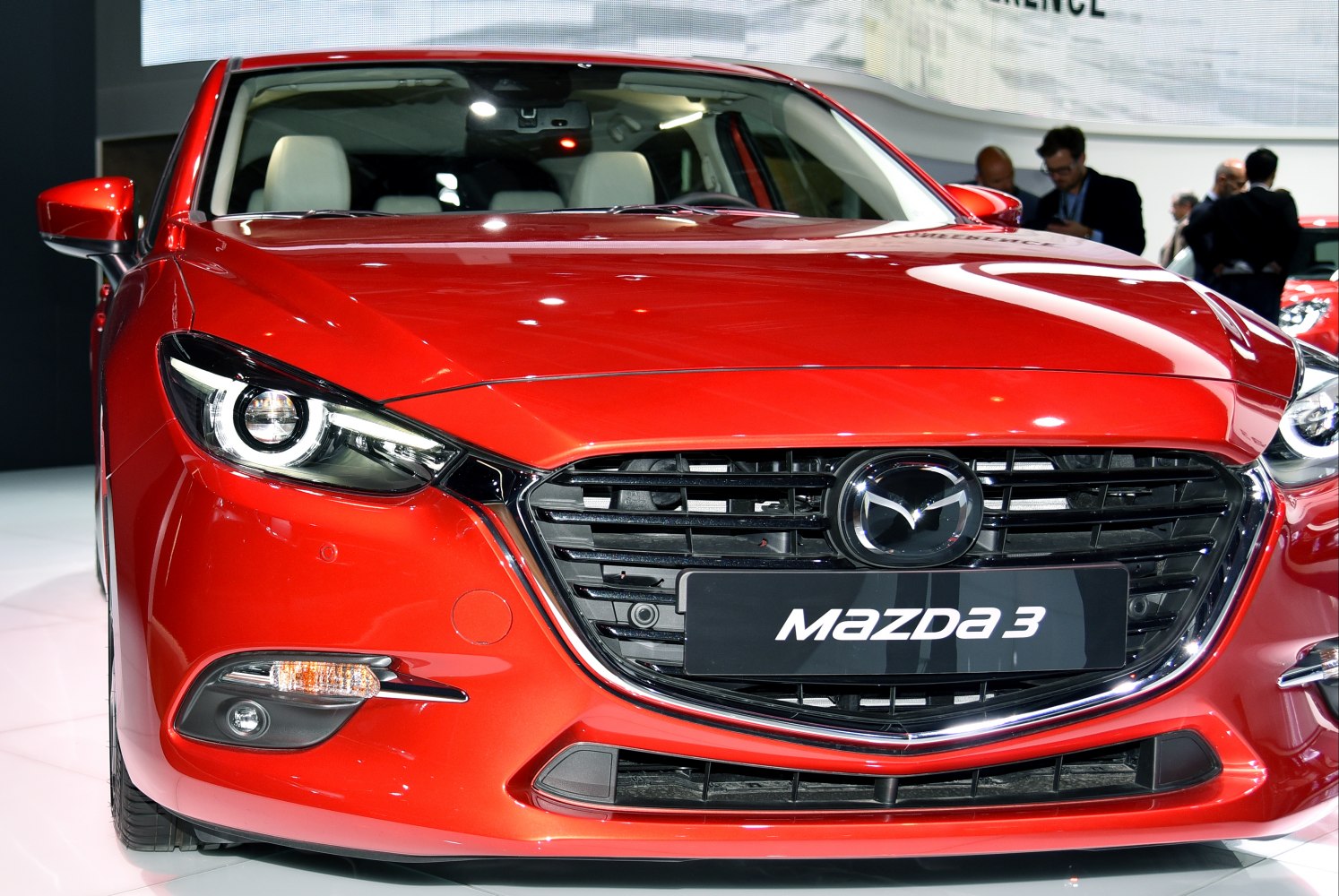 Close-up of front grille and headlights of a red hatchback