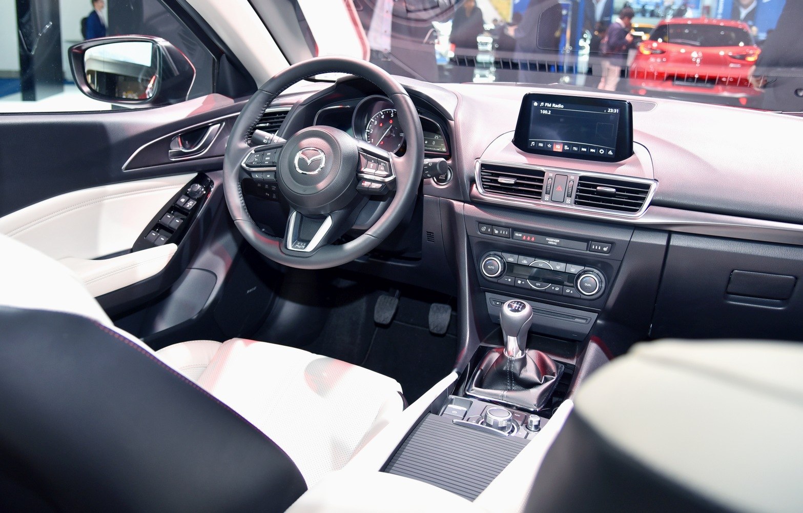 Modern car interior with dashboard, steering wheel, and manual transmission gearshift