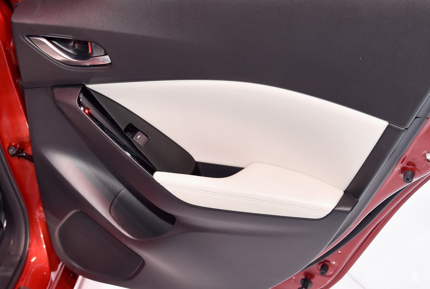 Interior door panel with black and white upholstery and window control switch