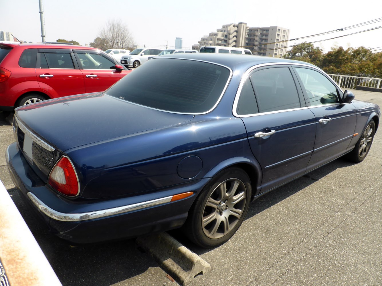 Luxury sedan rear-side profile with chrome trim and alloy wheels