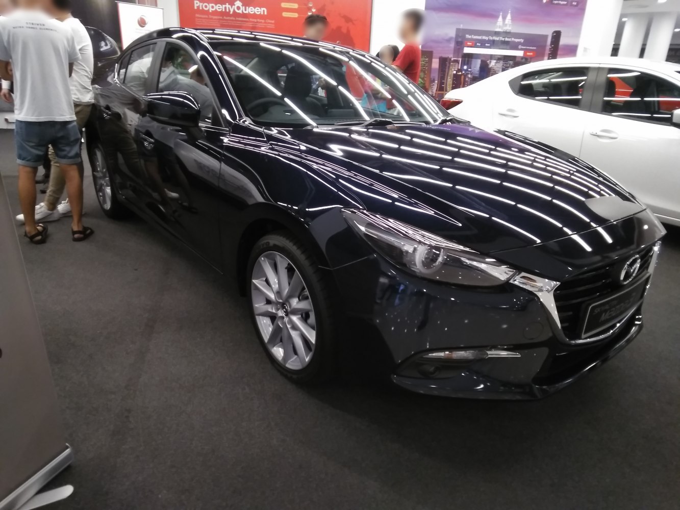 Black sedan front view with LED headlights and alloy wheels