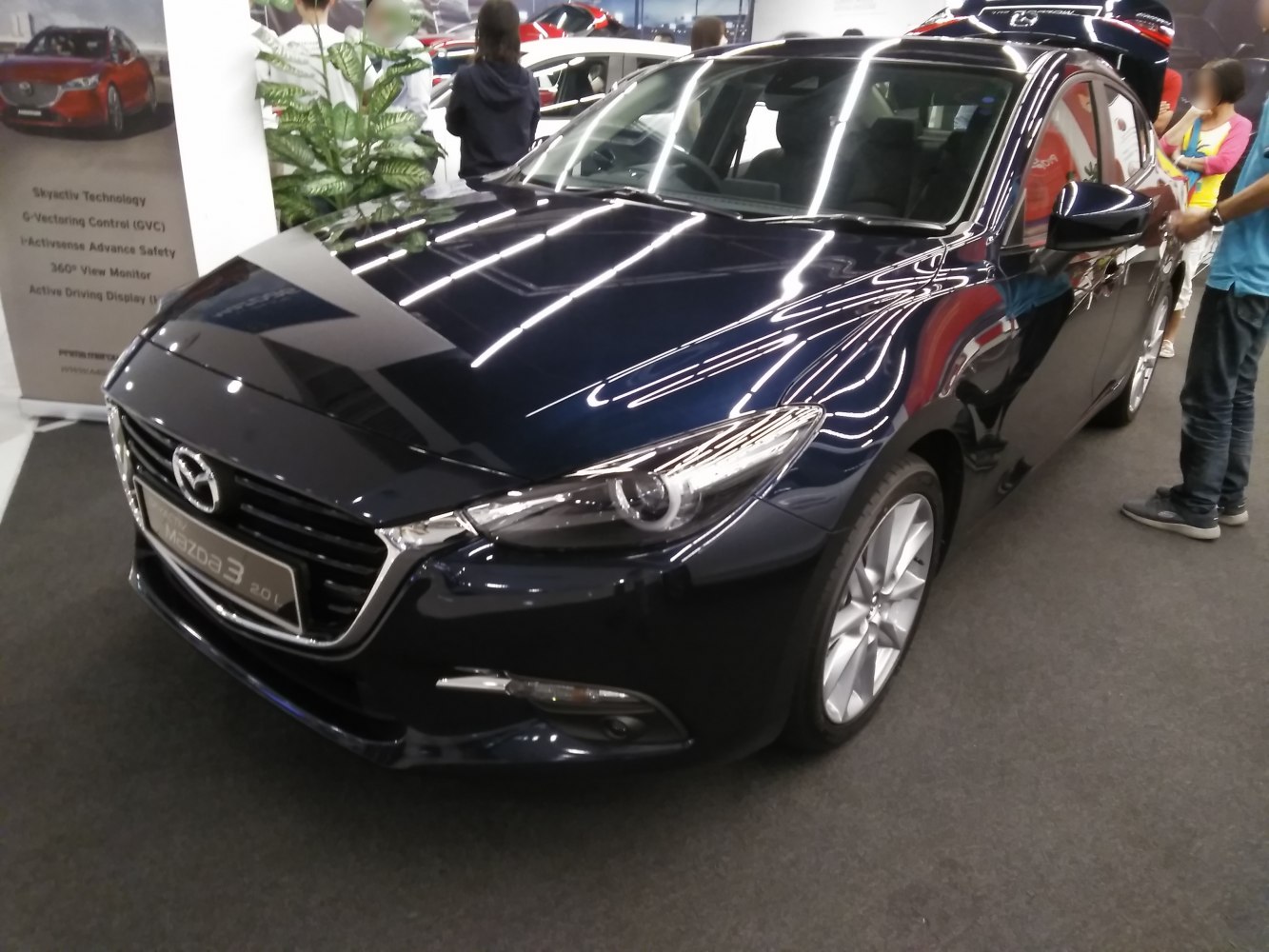 Front-side view of modern sedan with headlight and grille details