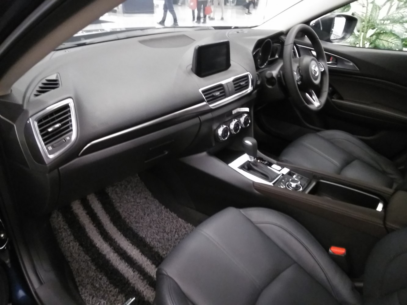 Dashboard, infotainment screen, center console with gear shift and climate controls
