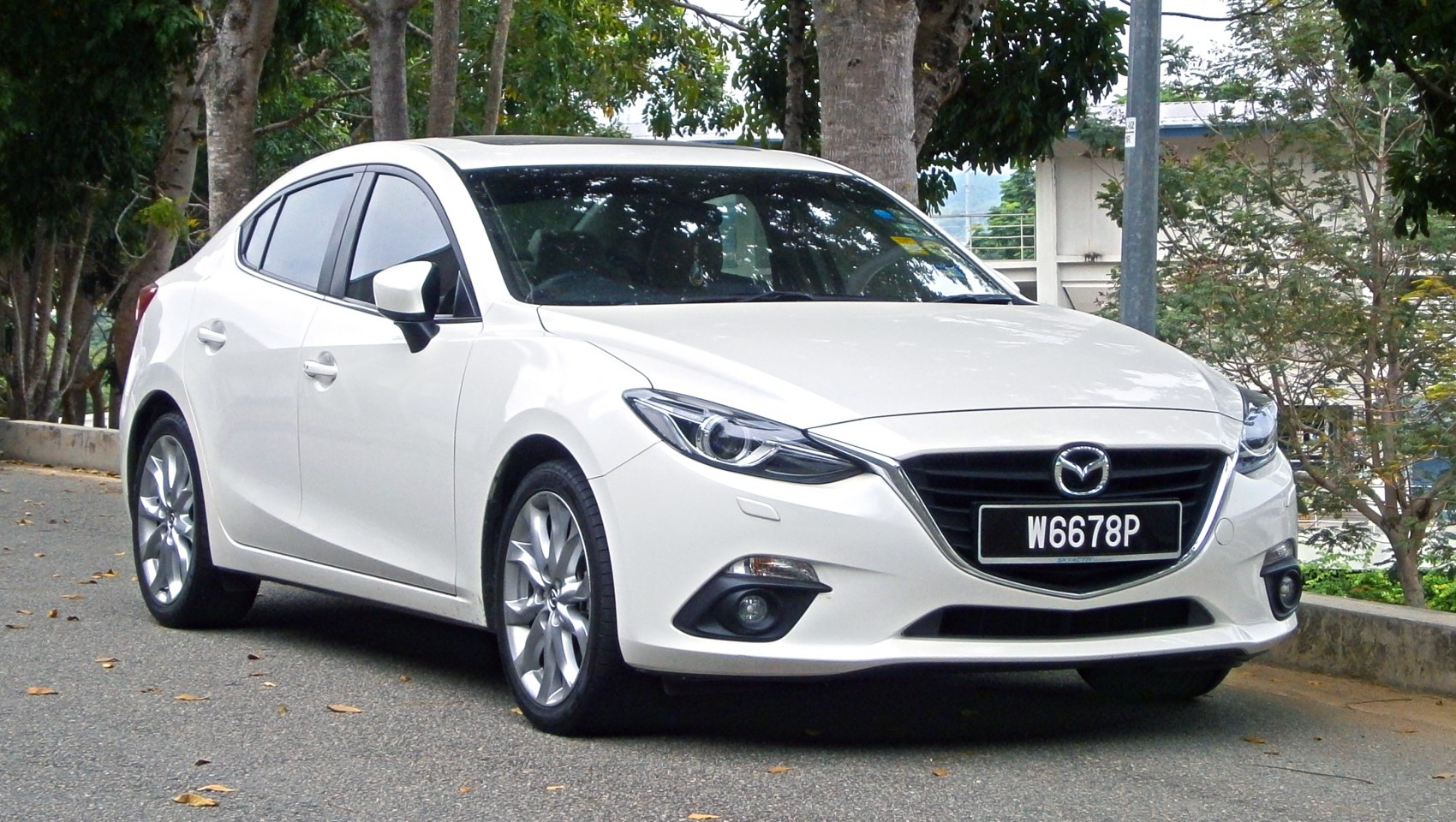 Front sedan view with sleek headlights and bold grille