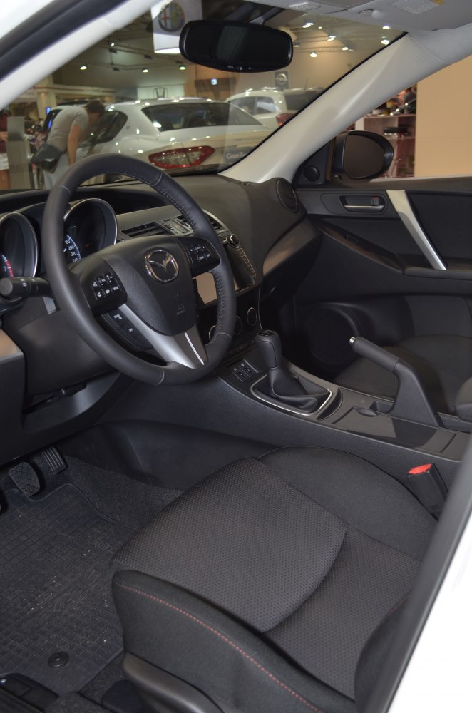 Mazda 3 TAKUMI 2012 interior with dashboard, steering wheel, and center console