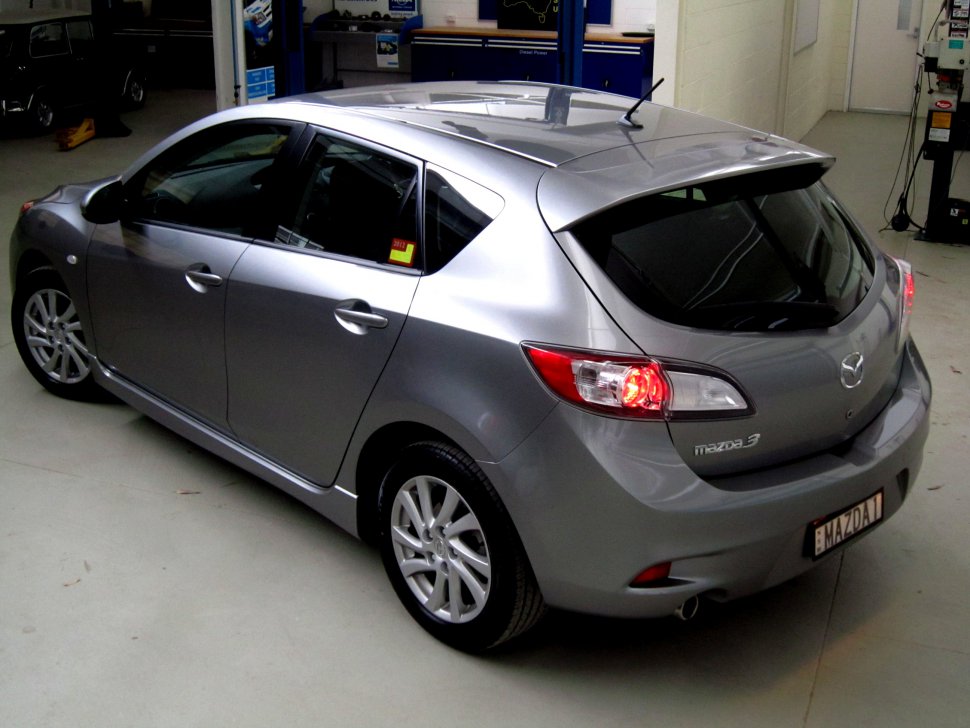 Silver compact hatchback rear-side view with visible tail lights and sporty design