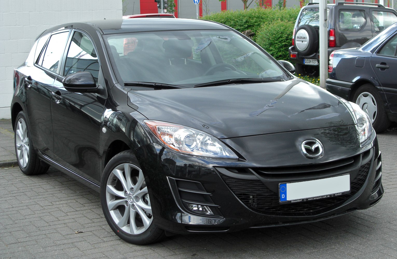 Front angled view with headlights and grille of a hatchback