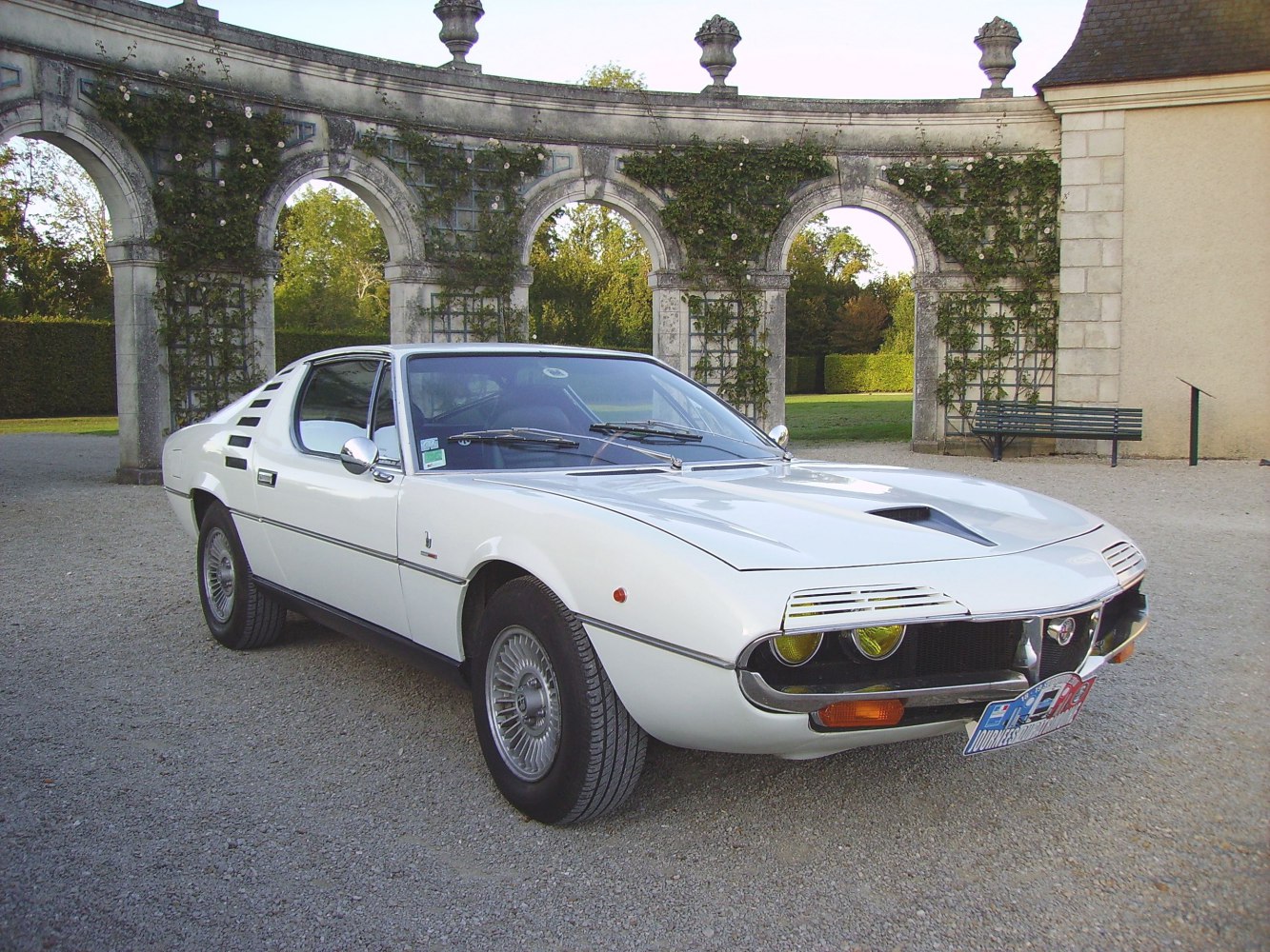 Classic sports coupe with distinctive headlight covers and side vents.