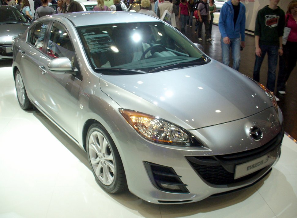 Silver sedan with sleek headlights and alloy wheels