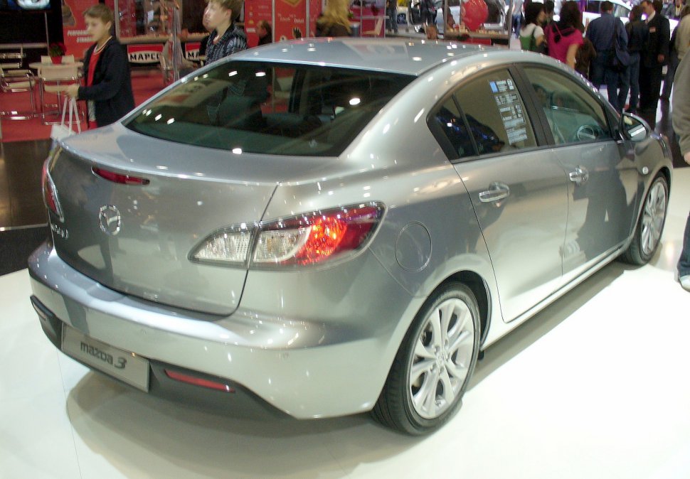 Silver sedan rear and side profile with sleek tail lights and alloy wheels