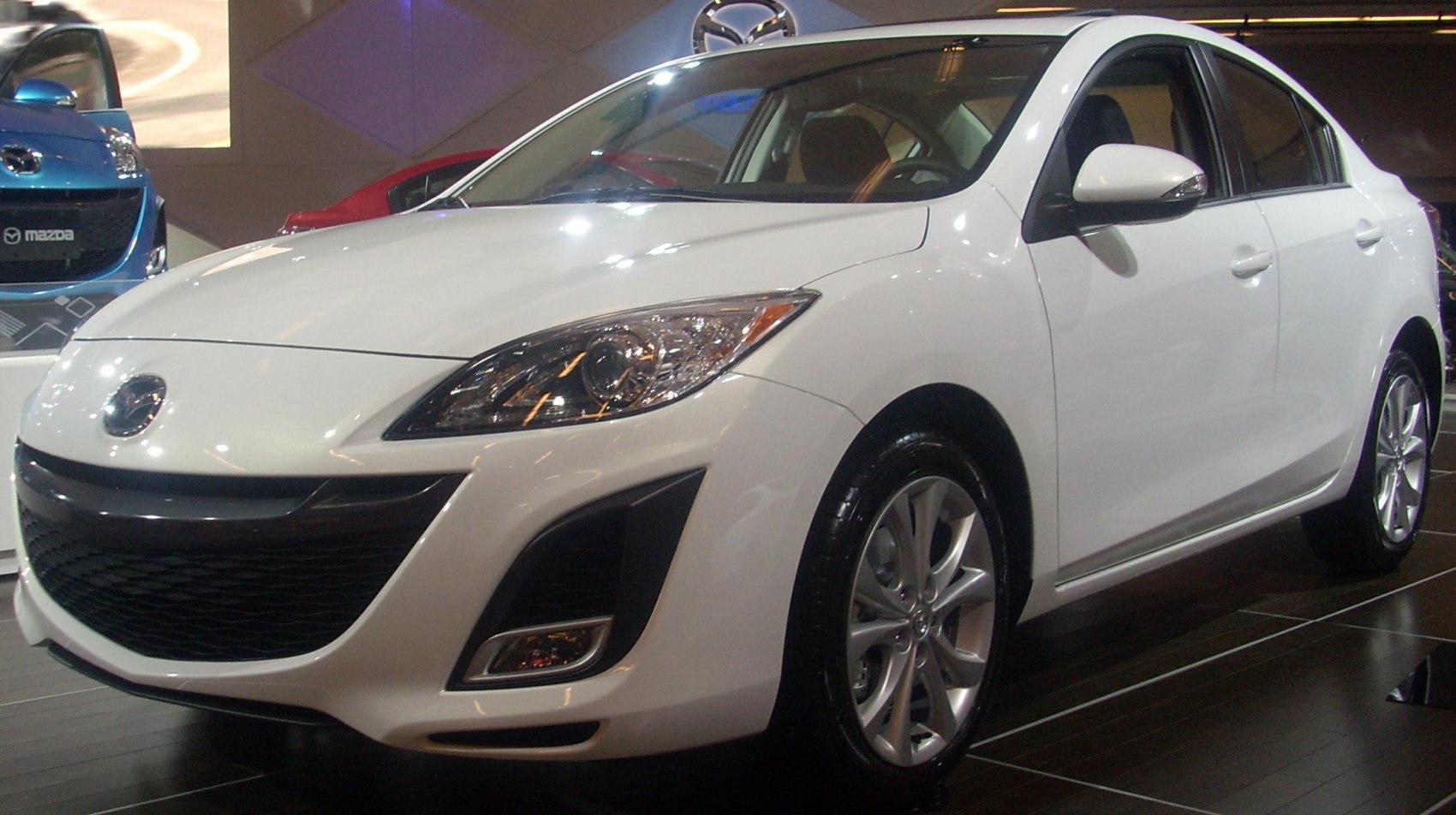 Front and side exterior view with headlights and alloy wheels