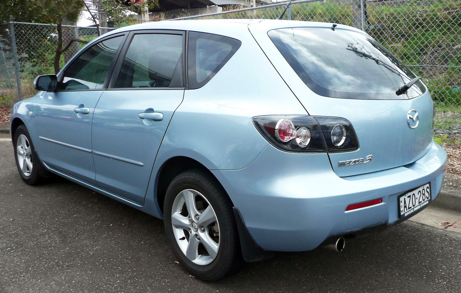 Rear and side view of five-door hatchback with distinctive taillights and alloy wheels