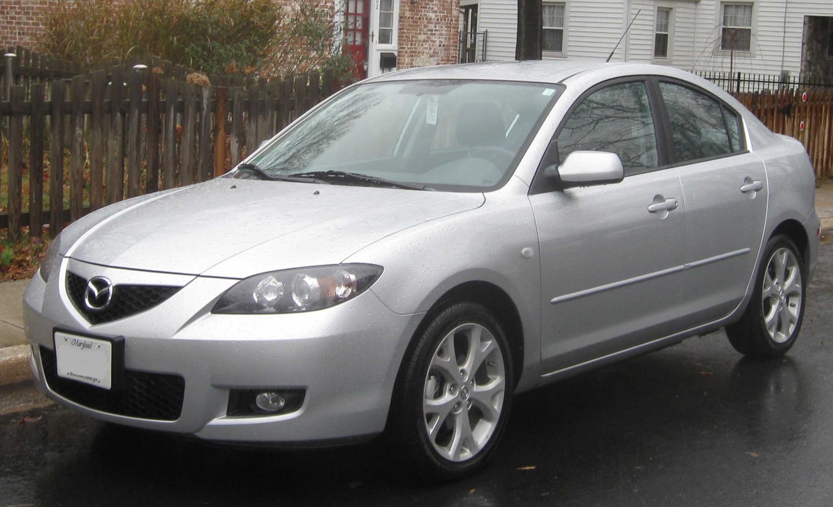 Sedan front side view with alloy wheels and sharp headlights.
