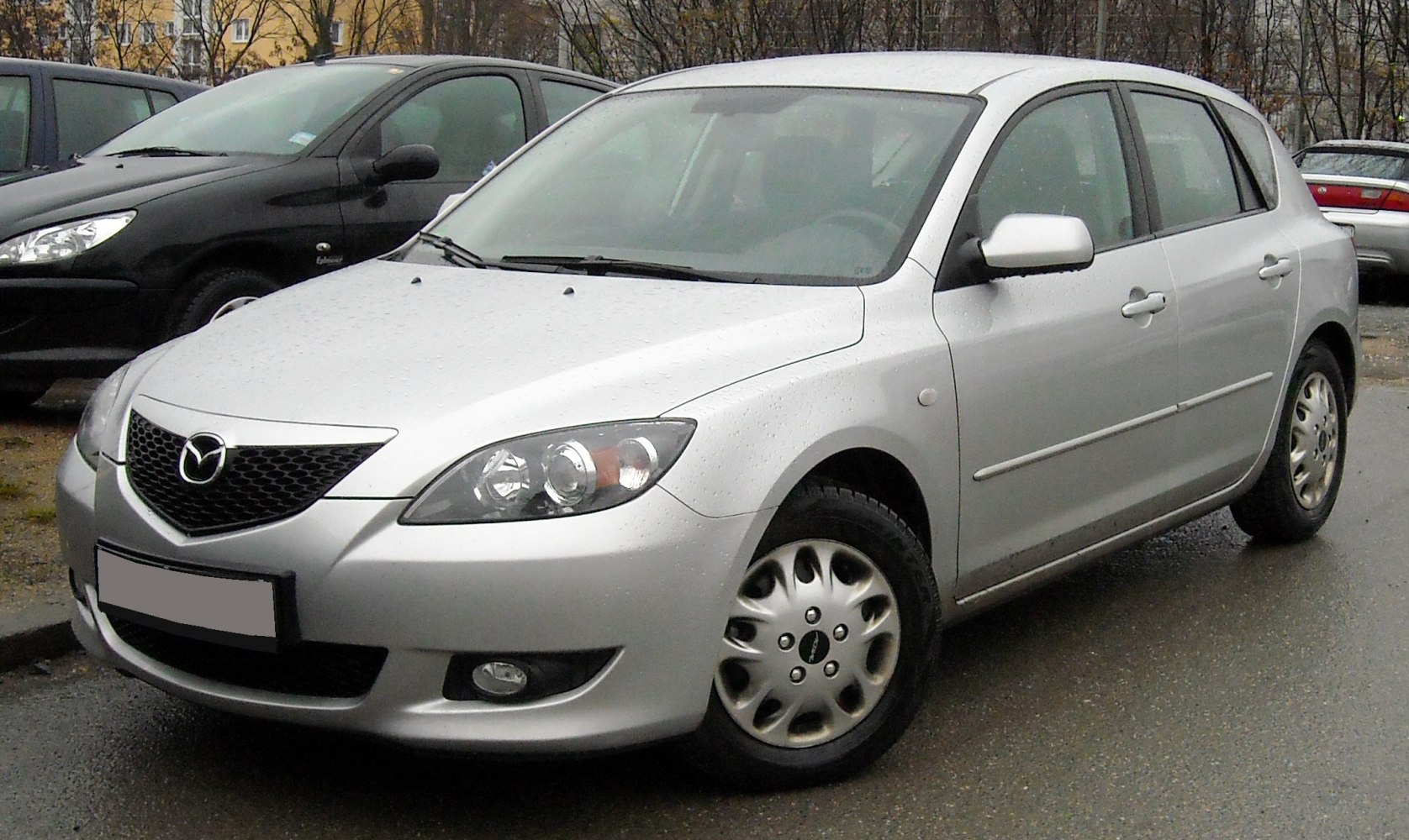 Front profile with distinctive headlights and hatchback body