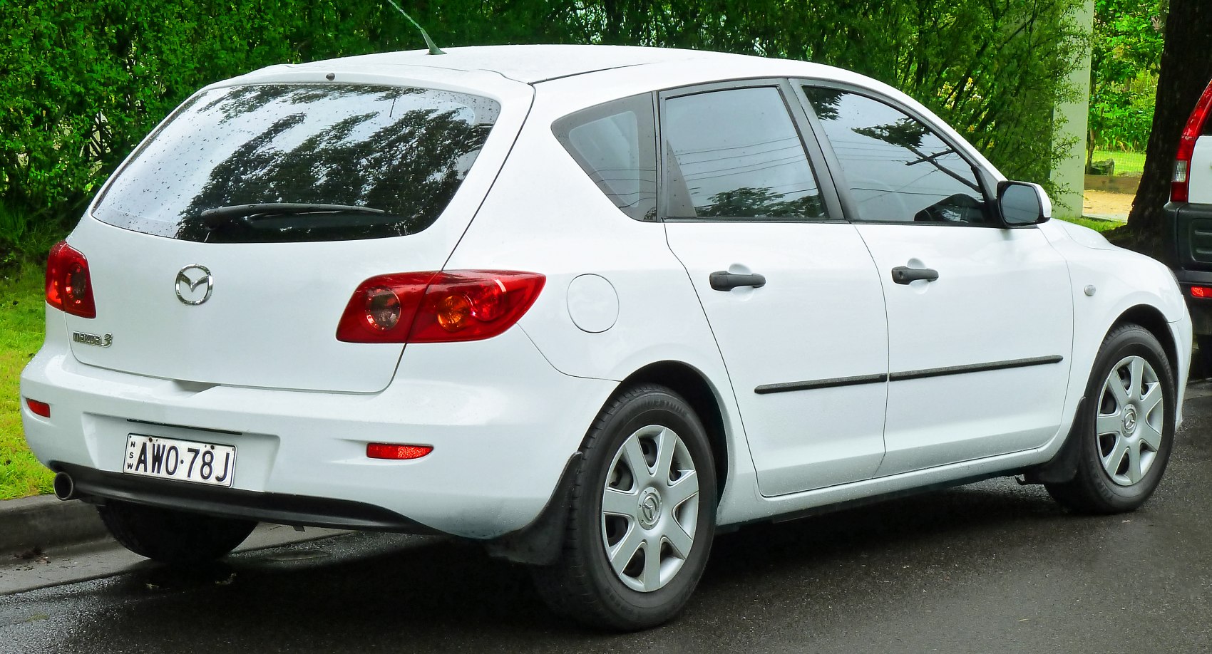 Rear and side view of white five-door hatchback with rounded rear lights