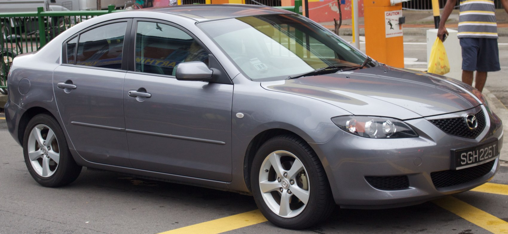Sleek sedan front side with aerodynamic headlights and alloy wheels