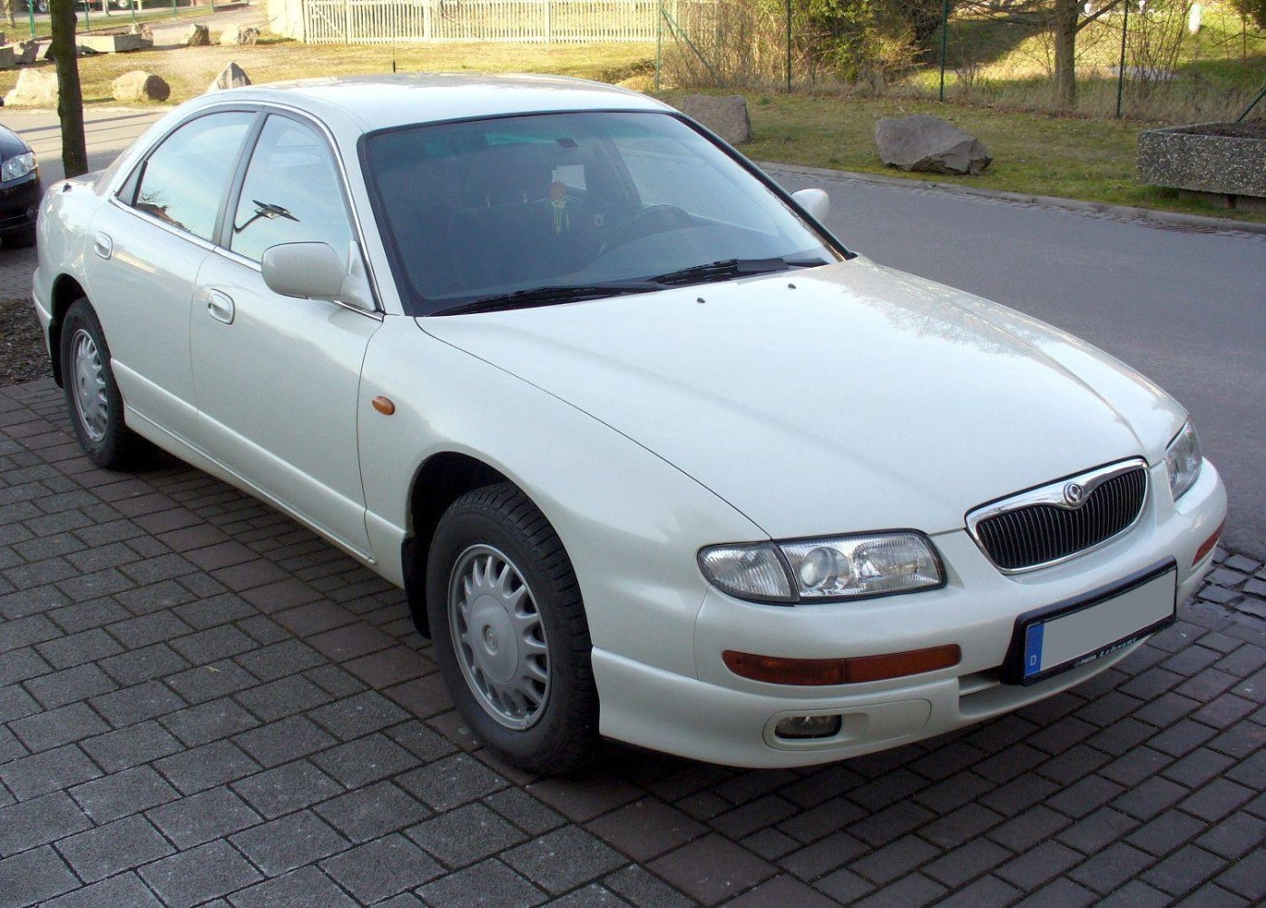 Front side view of a 1993 sedan with smooth lines and distinctive headlights