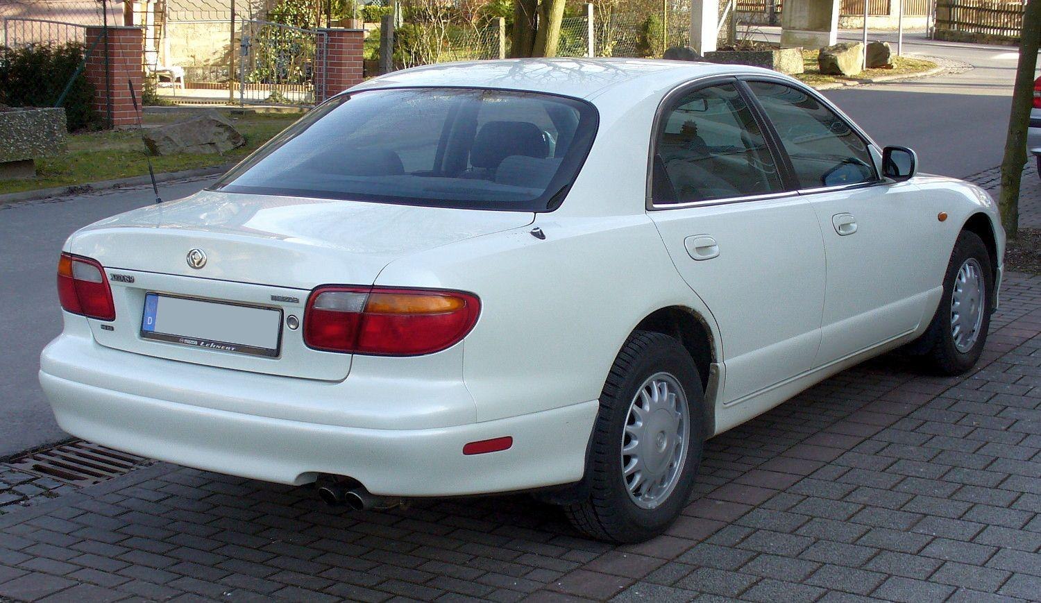 Sedan rear and side view with rounded tail lights and smooth body design