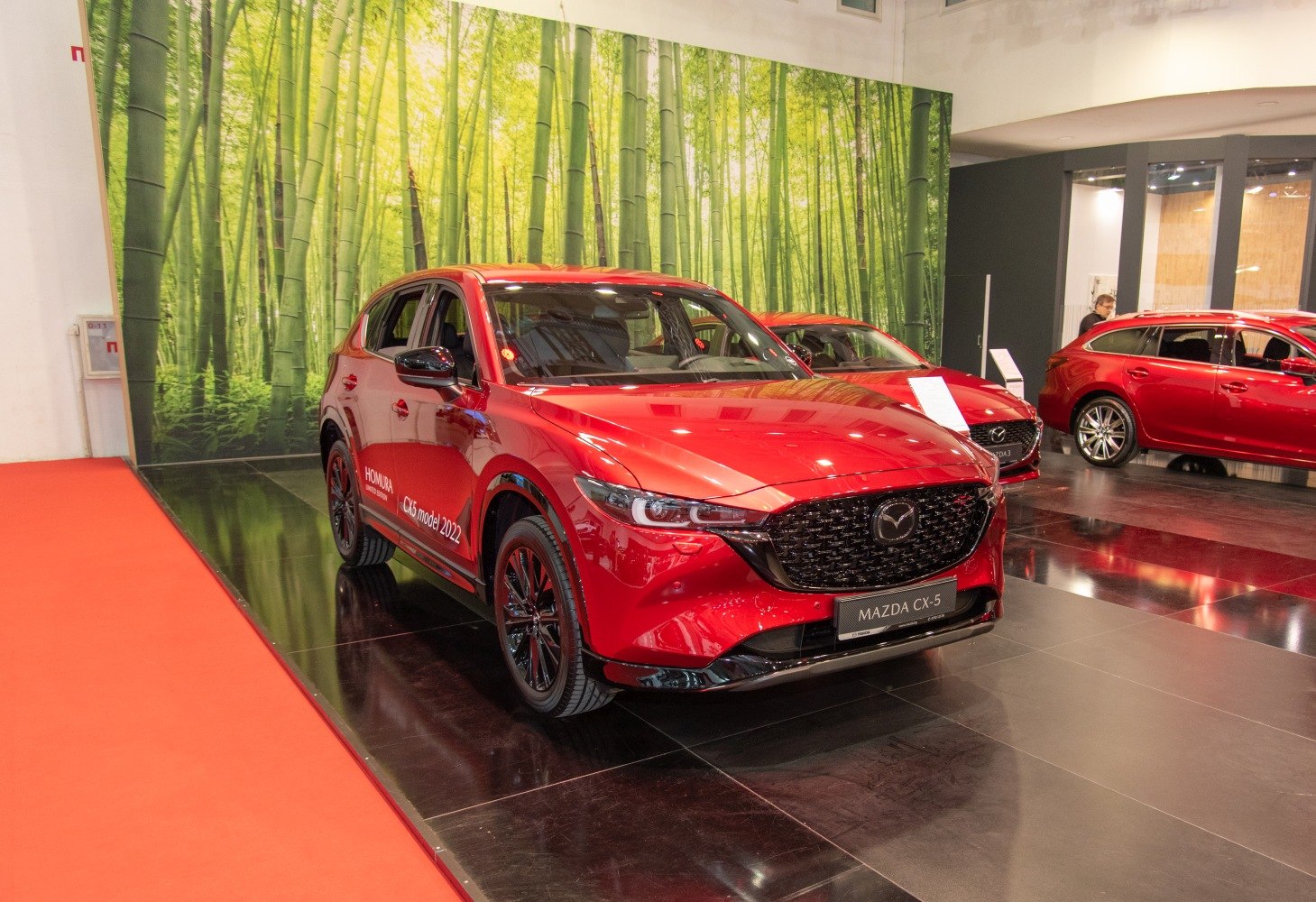 Front angled view of red SUV with black grille and sporty design